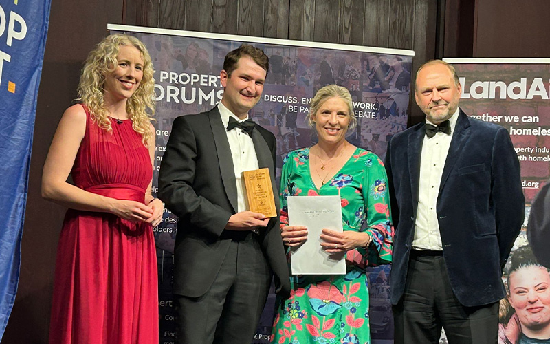 Team being presented with award on stage